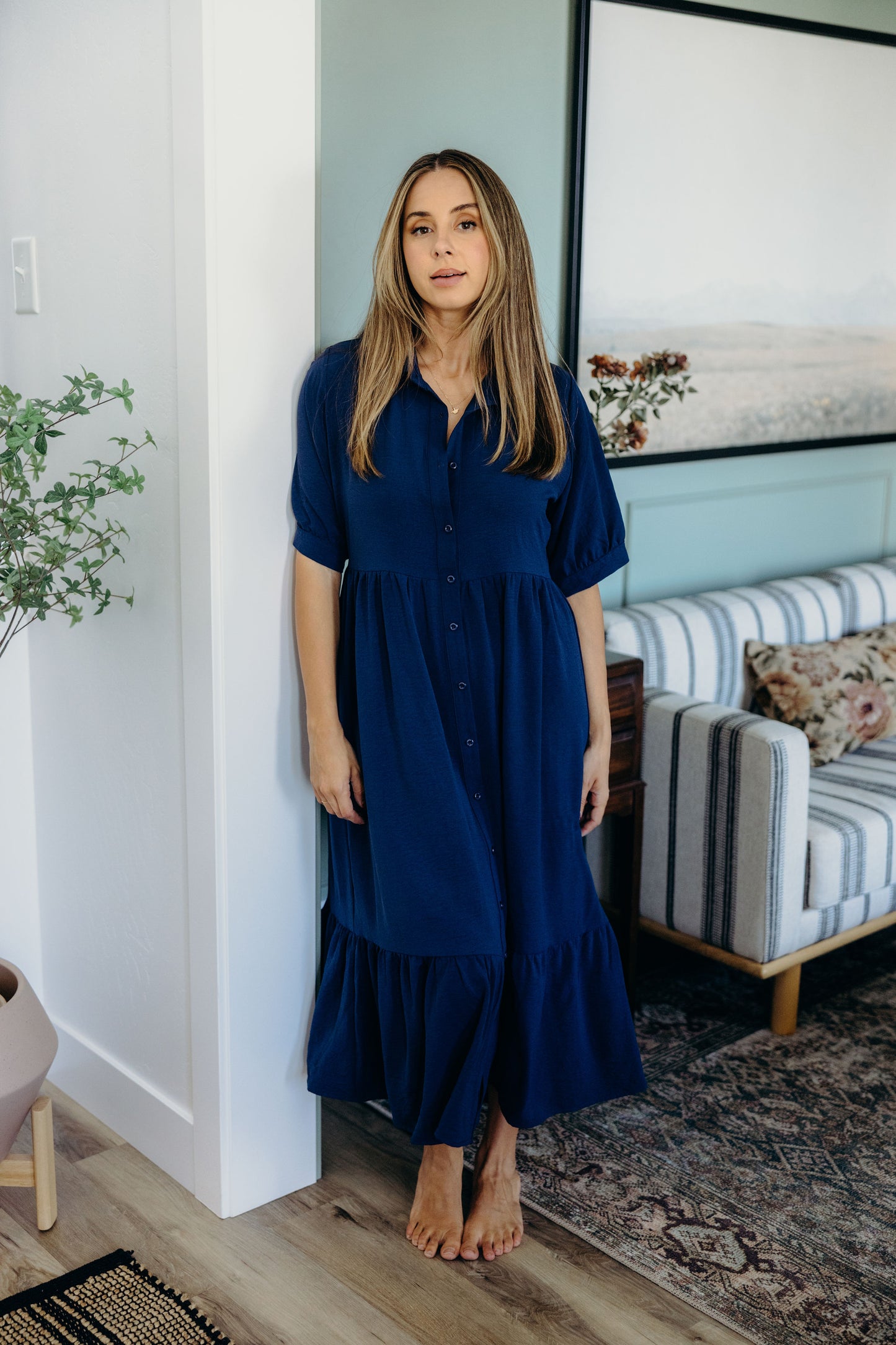 Full length dress with ruffle hem, natural waist, v neckline, short sleeves, collar and button down detail.