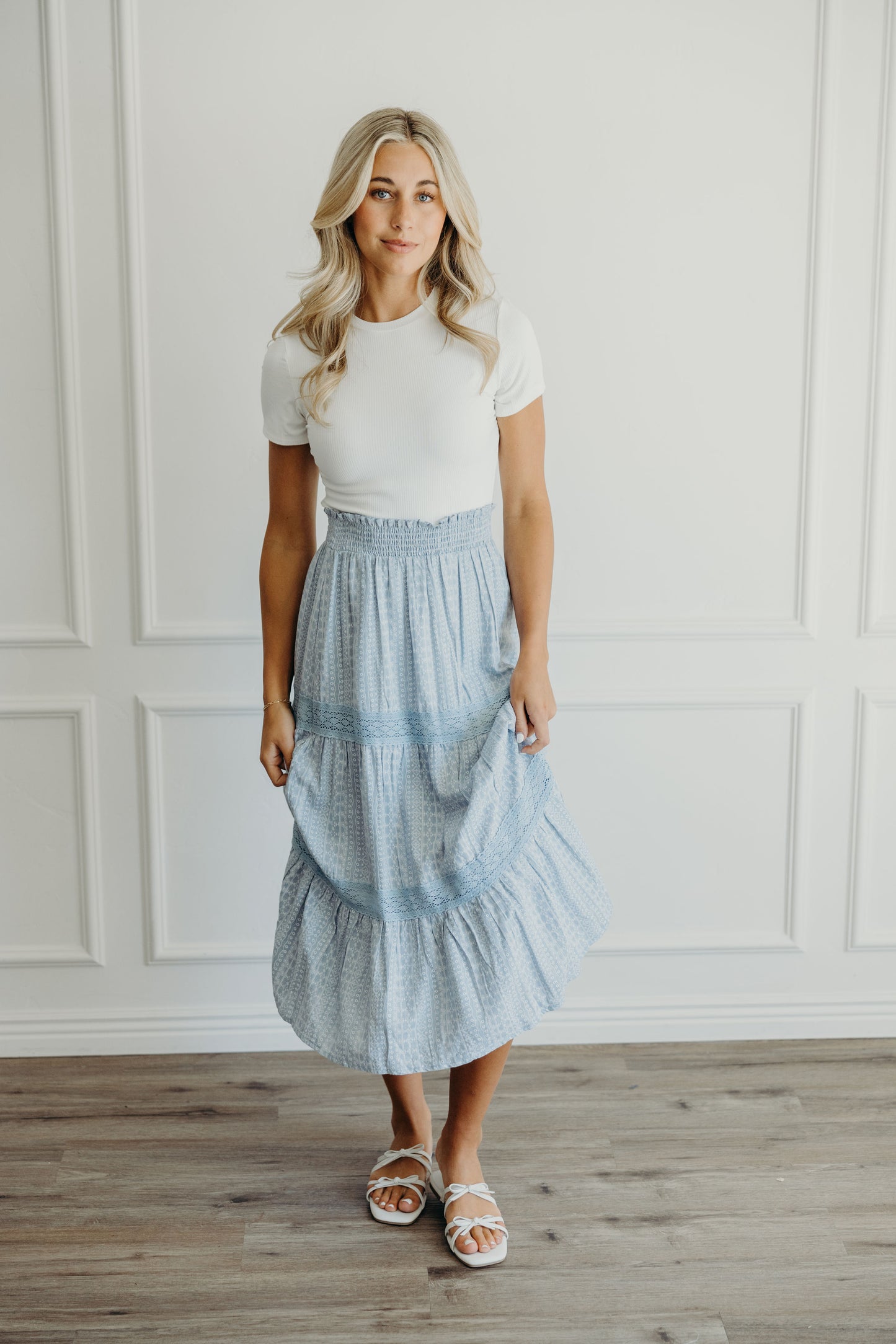 Blue geometric print tiered skirt with lace detail and ruched waist.