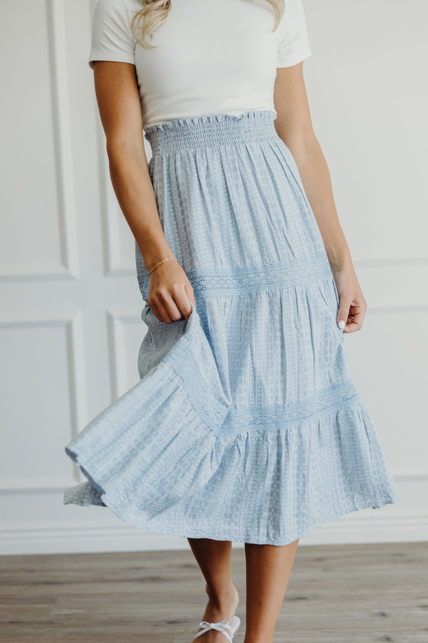 Blue print midi length skirt with lace detail on tiers with ruched elastic waist.