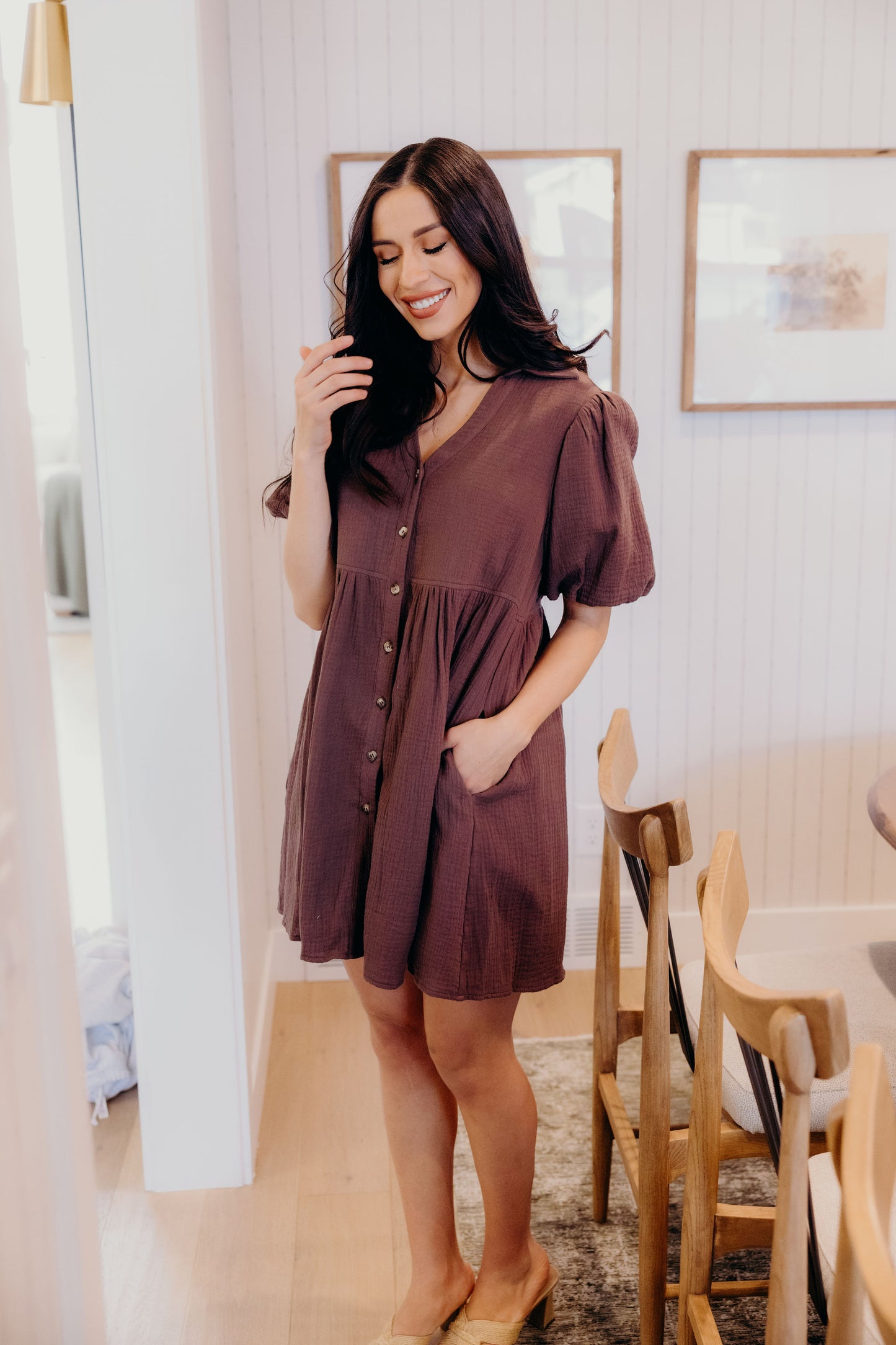 Chocolate brown button down dress with v neckline and pockets.