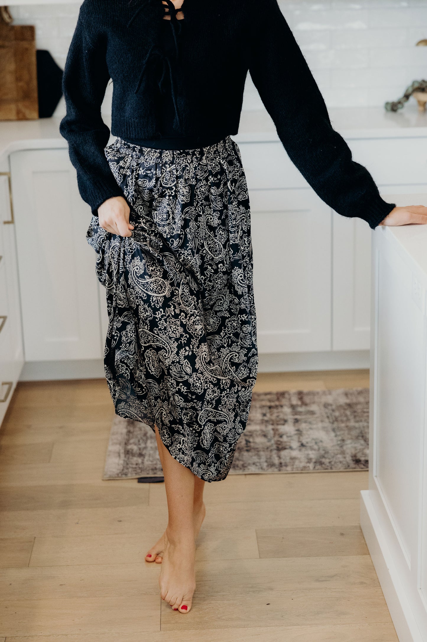 Black paisley print skirt with a line silhouette.