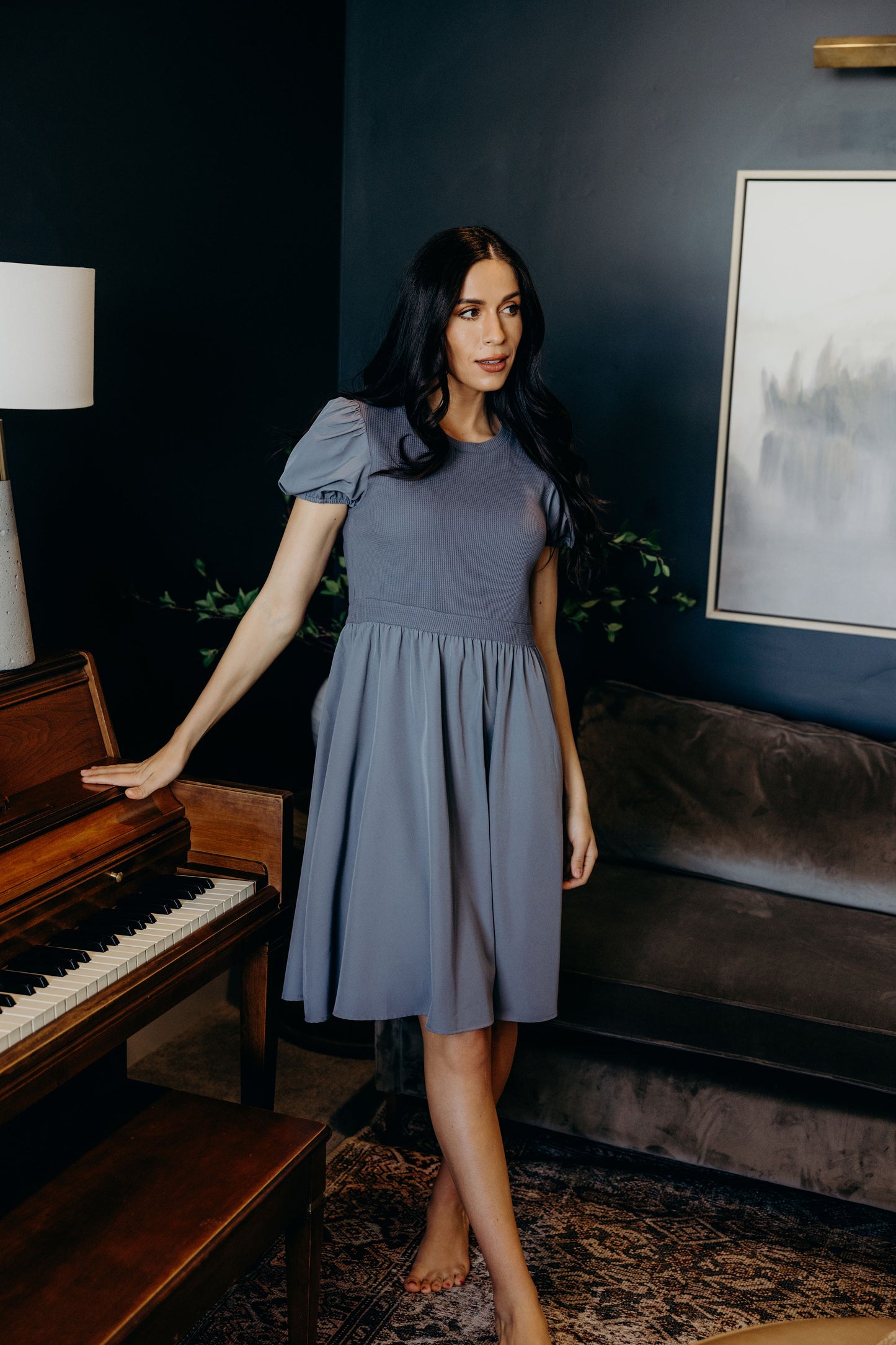 Knee length cornflower blue dress with textured bodice and short sleeves.