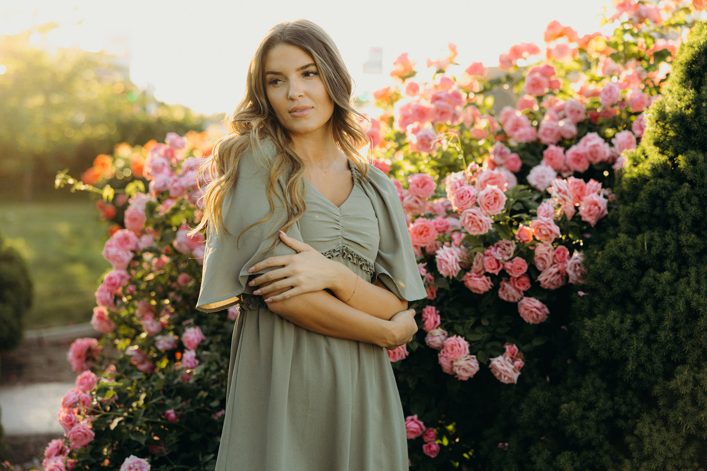 Green dress with oversized sleeves, sweetheart neckline, and ruffle detail at waist.