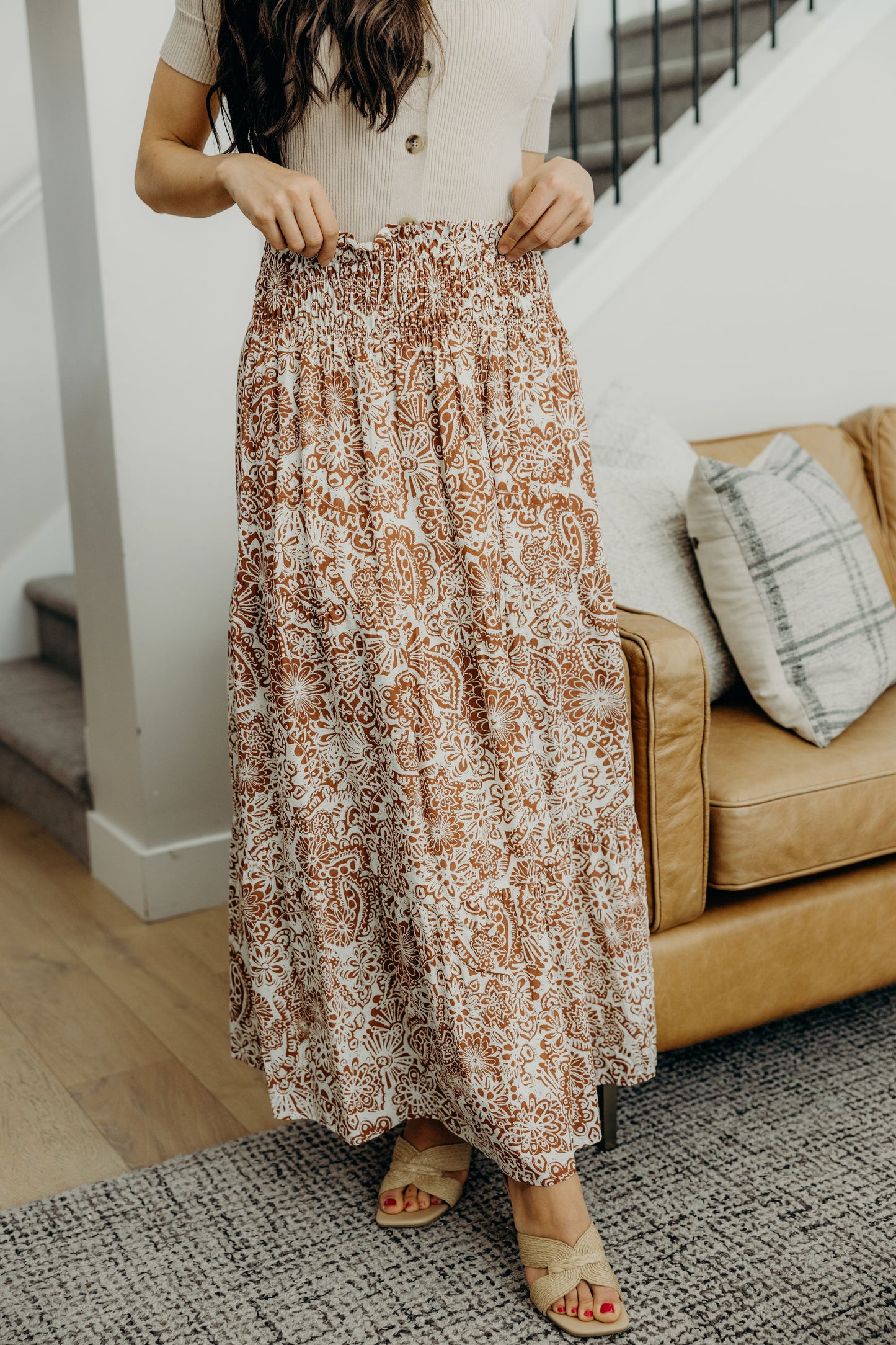 A line smocked waisted tiered maxi skirt with copper and cream paisley print.
