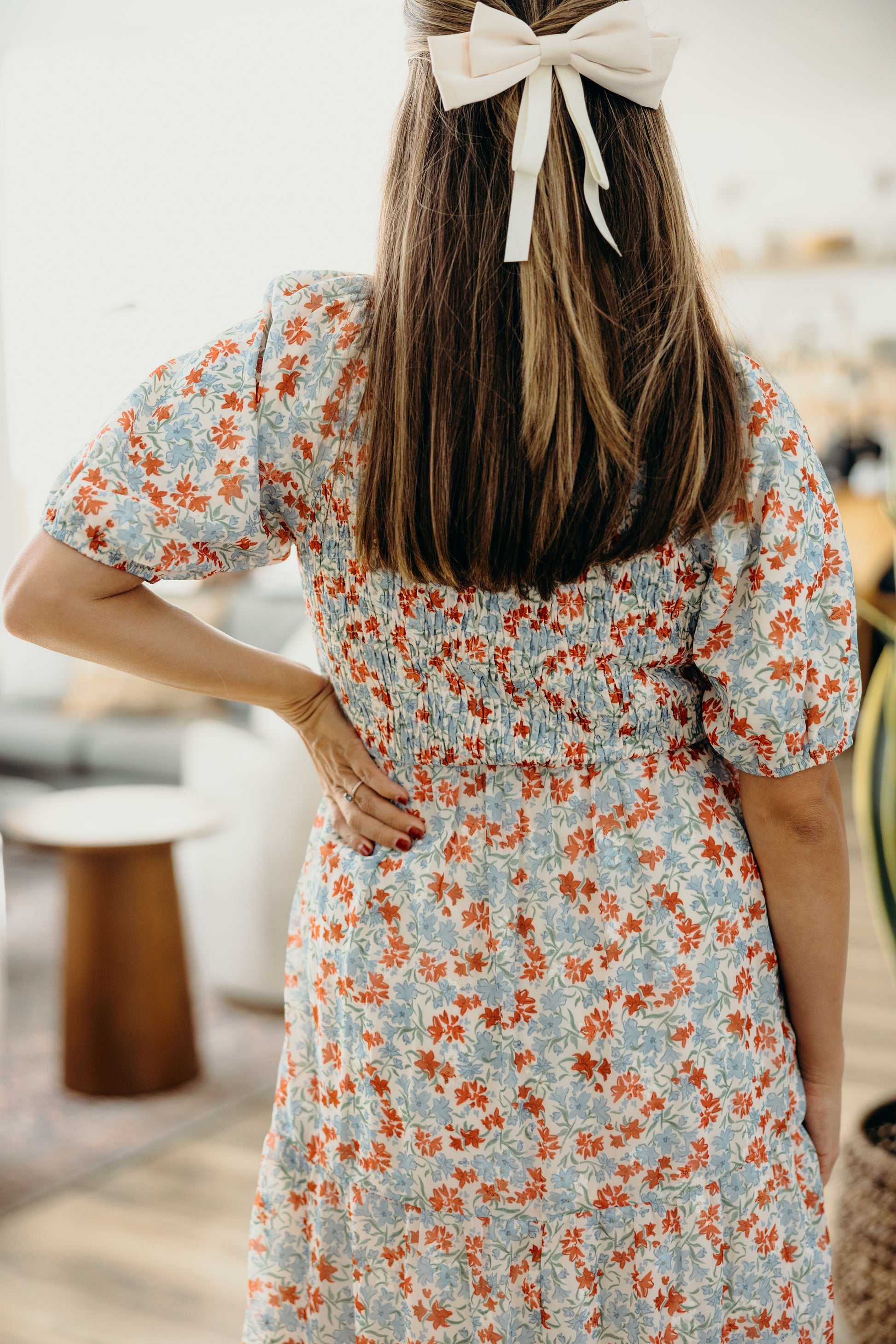 Back view of smocked bodice dress with natural waistline, and short sleeves.