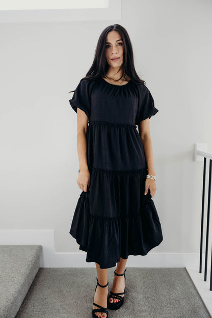Midi length tiered dress with natural waistline and puff sleeves.