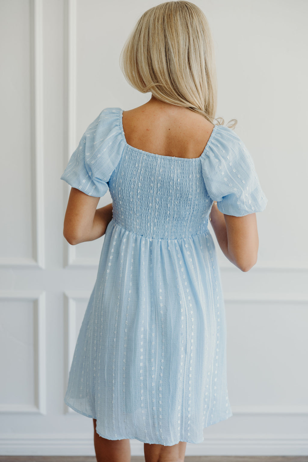 Short fit and flare dress with textured detail, smocked back and short puff sleeves.