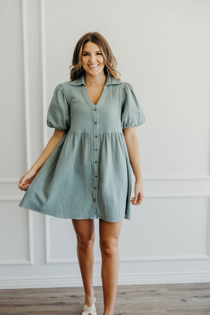 Knee length empire tiered mint green dress with button down detail, v neckline and short sleeves.