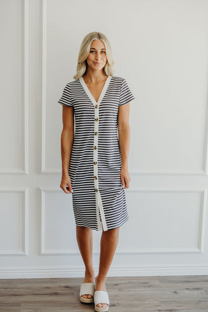 Knee length ribbed striped dress with short sleeves, button detail, and striped fabric.