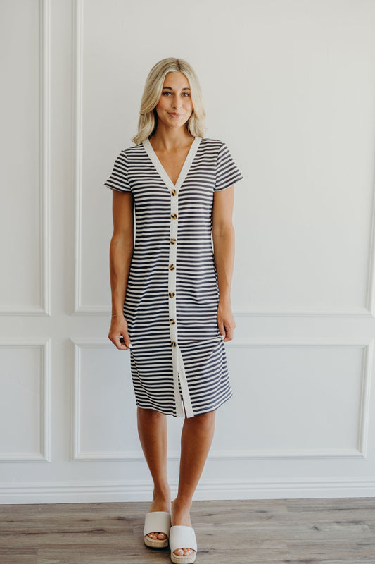 Knee length ribbed striped dress with short sleeves, button detail, and striped fabric.