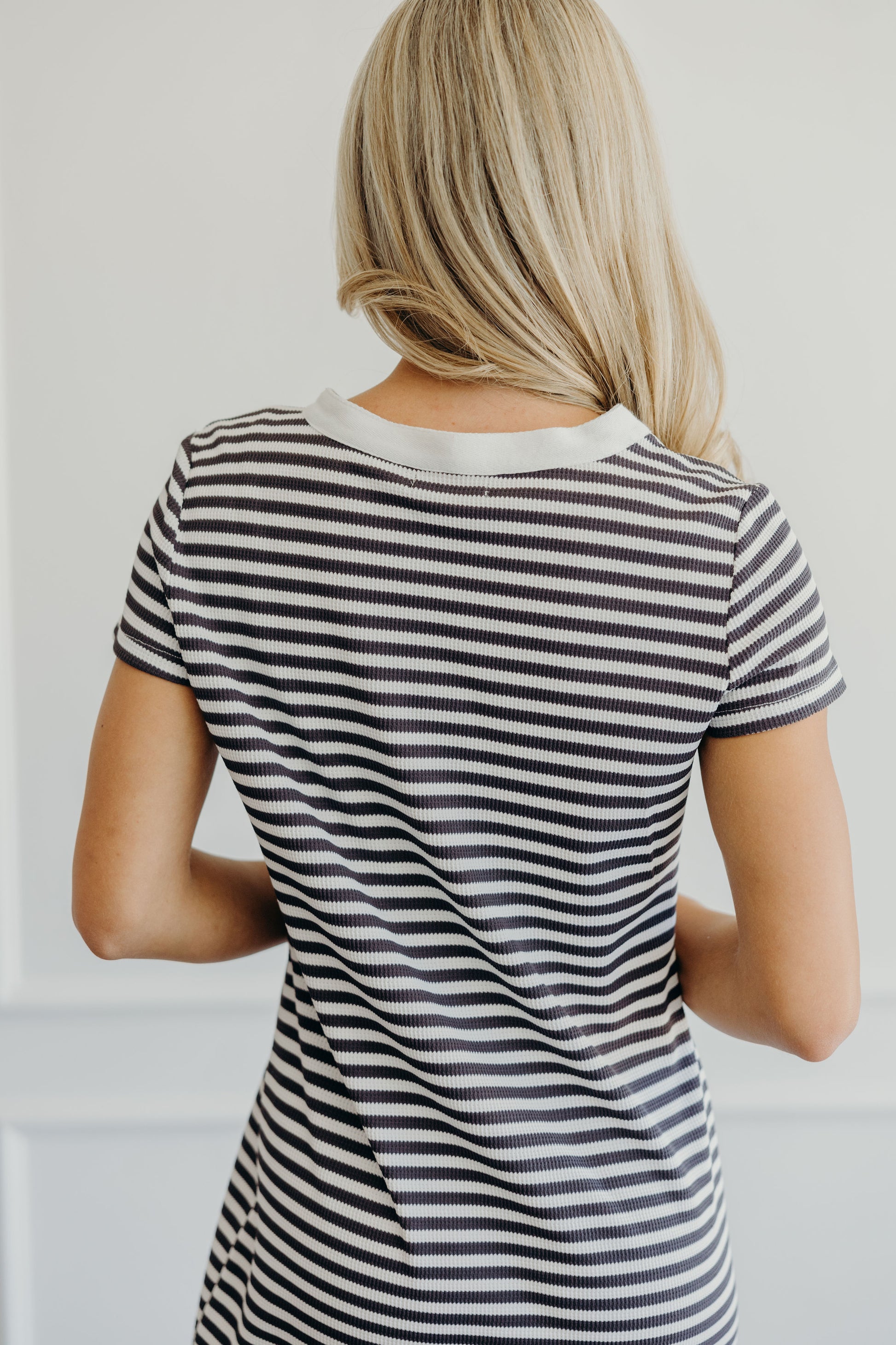 Back of dress with round neckline, short sleeve  and striped print.