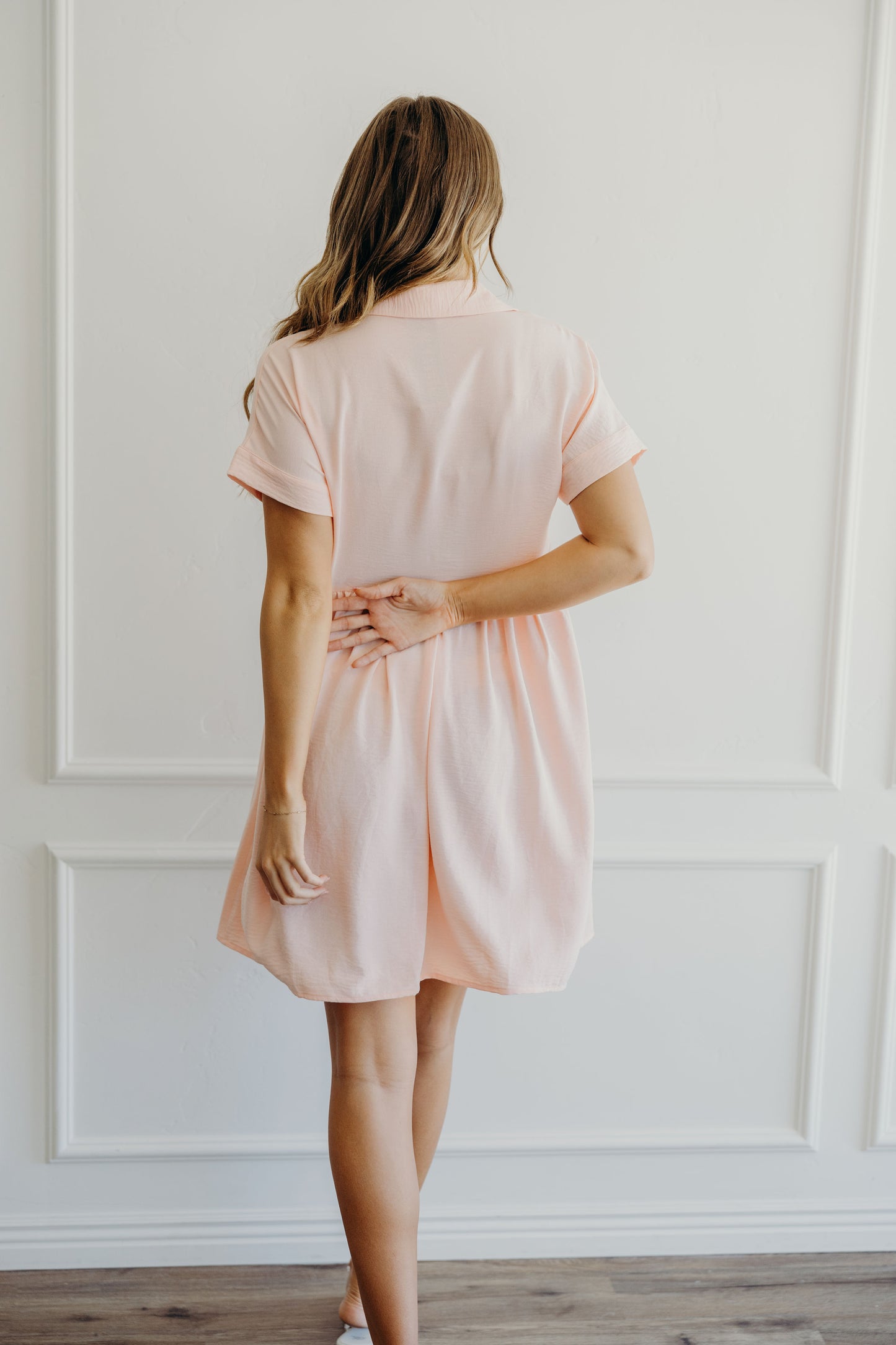 Short sleeve light pink knee length dress.