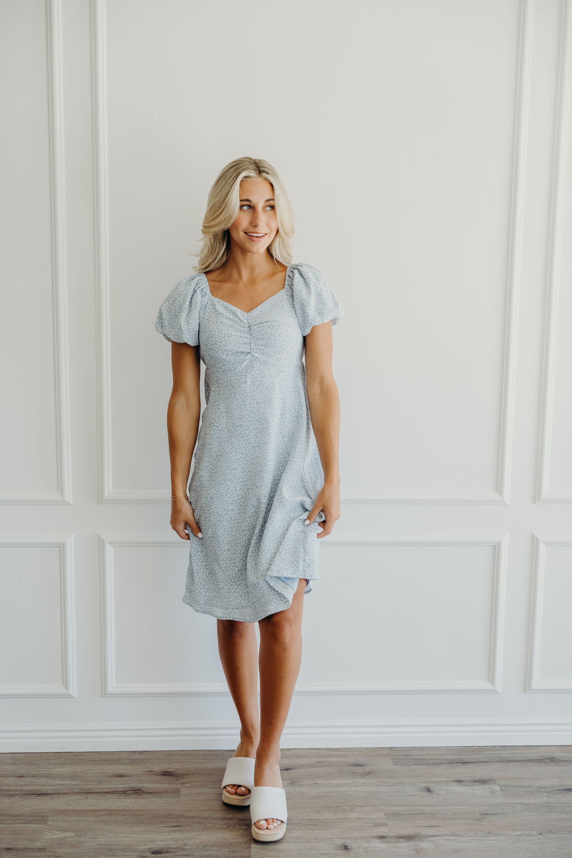 Knee length blue print dress with gathered bust.