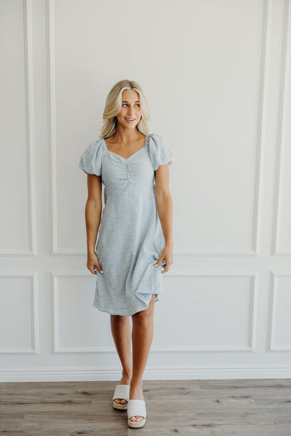 Knee length blue print dress with gathered bust.