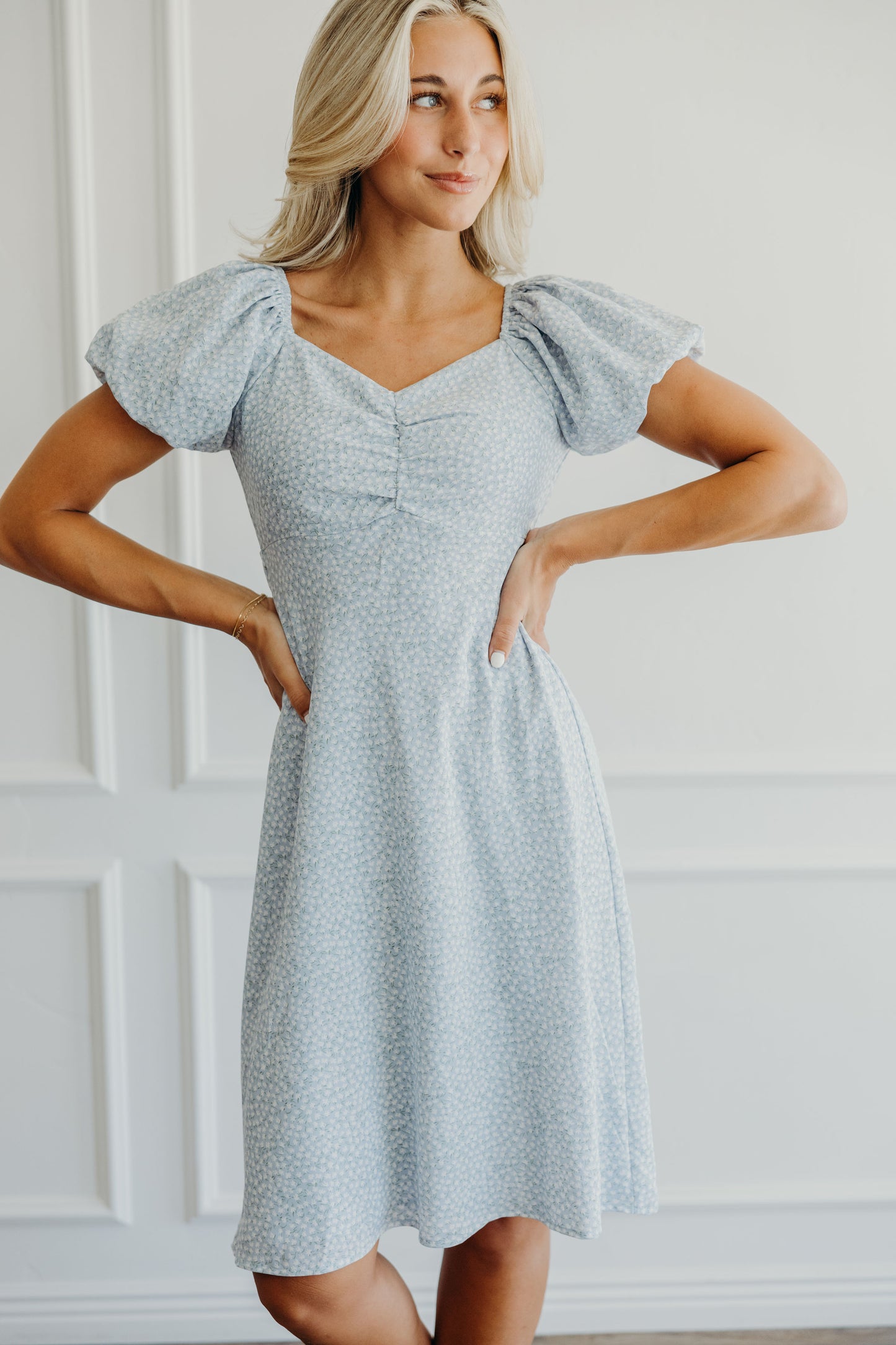 Blue print dress with white flowers, sweetheart neckline and puff sleeves.