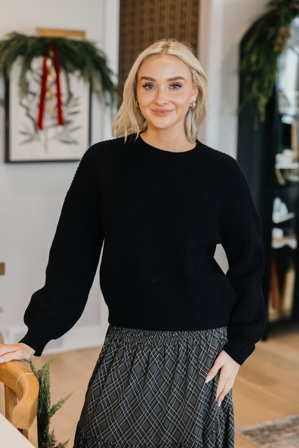 OVERSIZED SWEATER in black, long sleeve, featured in the 2026 Fall Collection, styled with a patterned skirt.