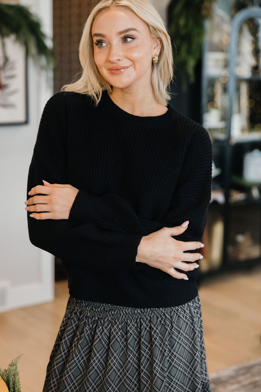 OVERSIZED SWEATER in black, long sleeve, featured in the 2026 Fall Collection, styled with a patterned skirt.