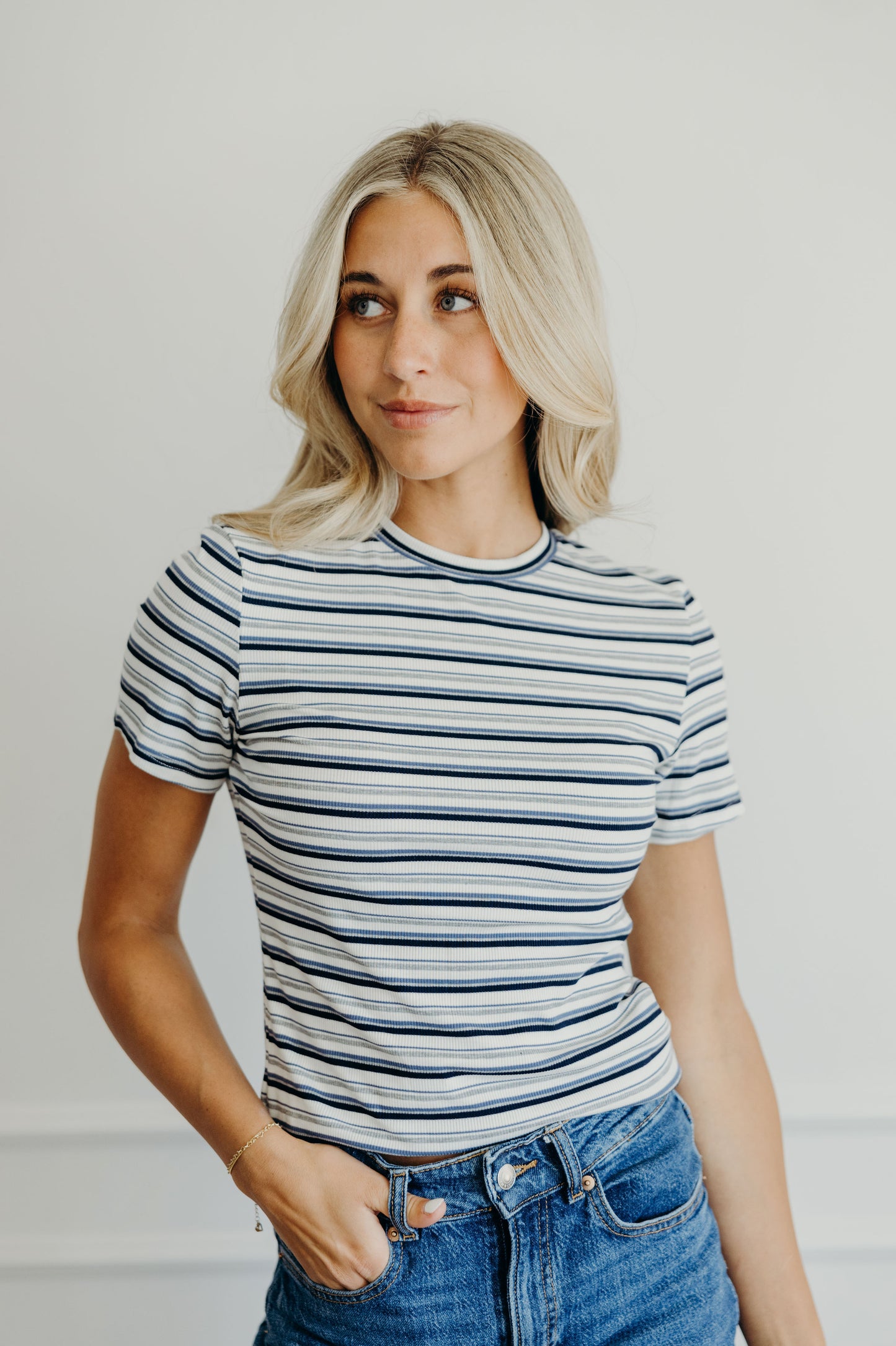 High neck blue striped t shirt with short sleeves.