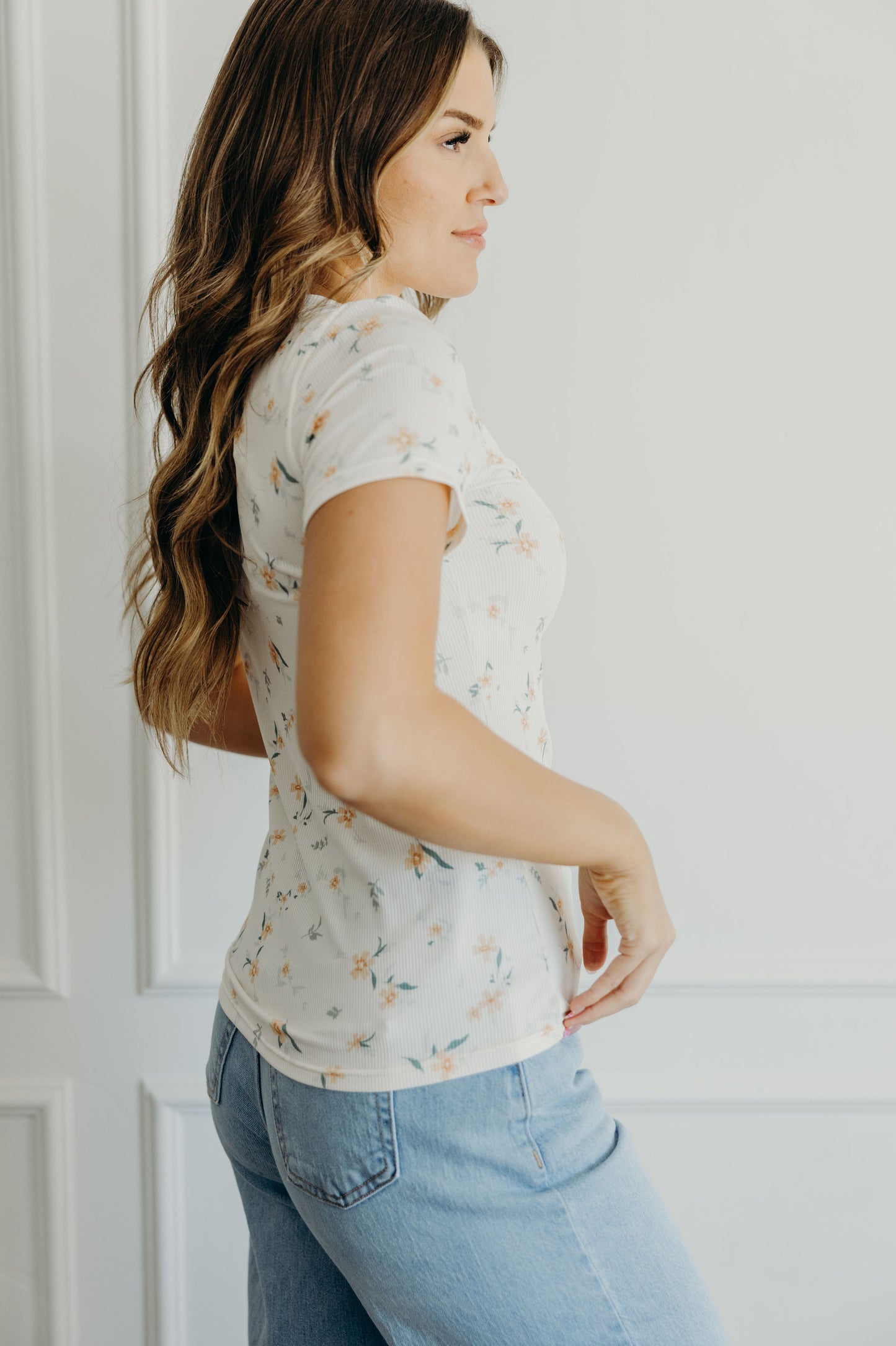 Short sleeve peach shirt with orange print.