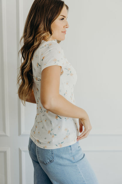 Short sleeve peach shirt with orange print.