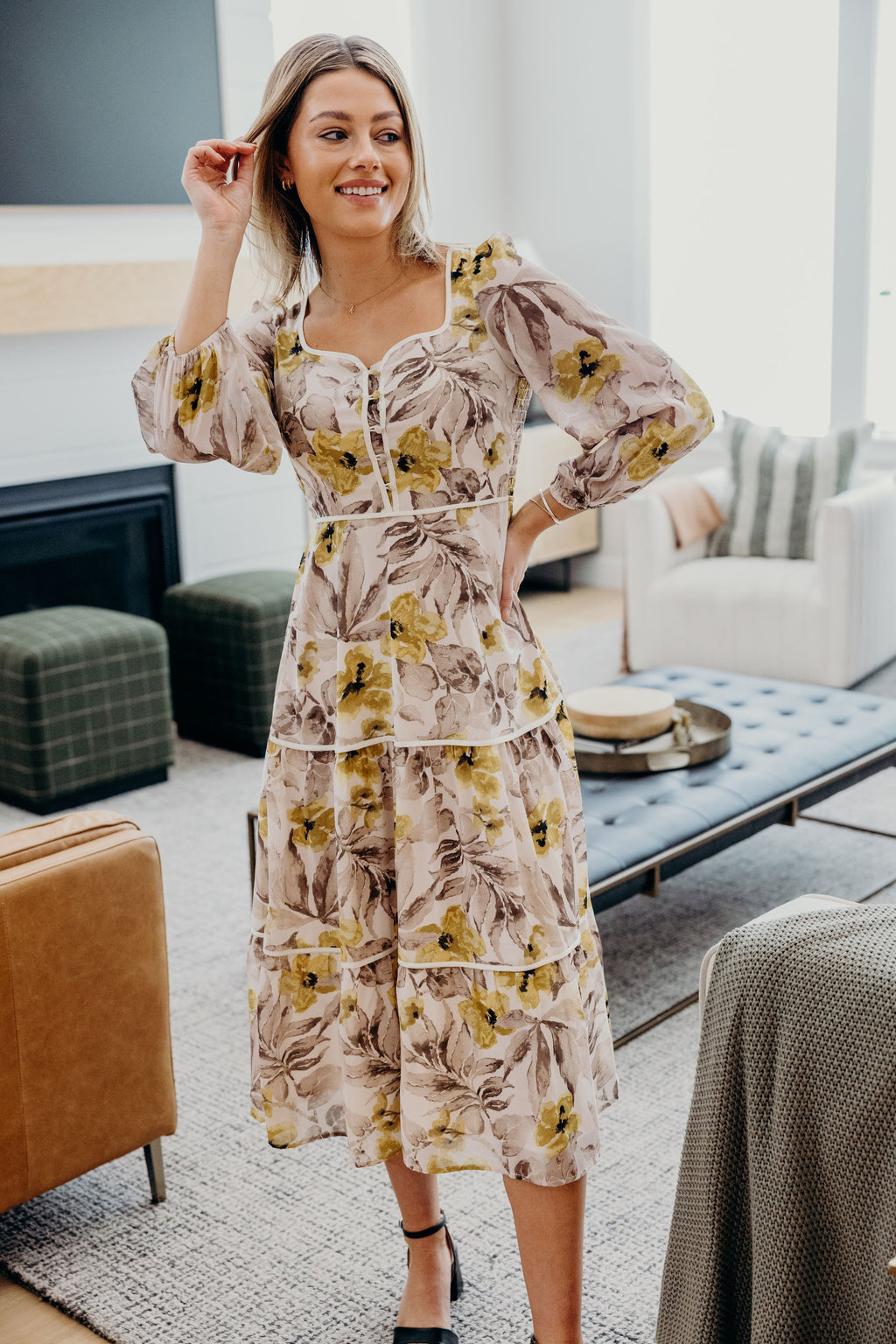 Cream floral dress with tiered skirt, sweetheart neckline, button detail and 3/4 sleeve with elastic cuffs.