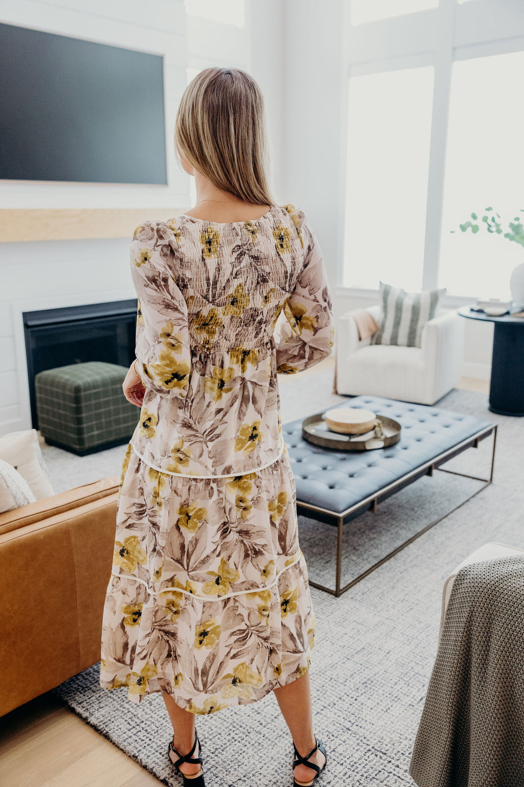 Tiered cream and gray floral print dress with smocked back and 3/4 sleeves.