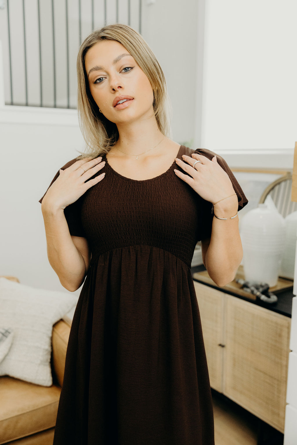 Short sleeve brown dress with smocked bodice and natural waistline.