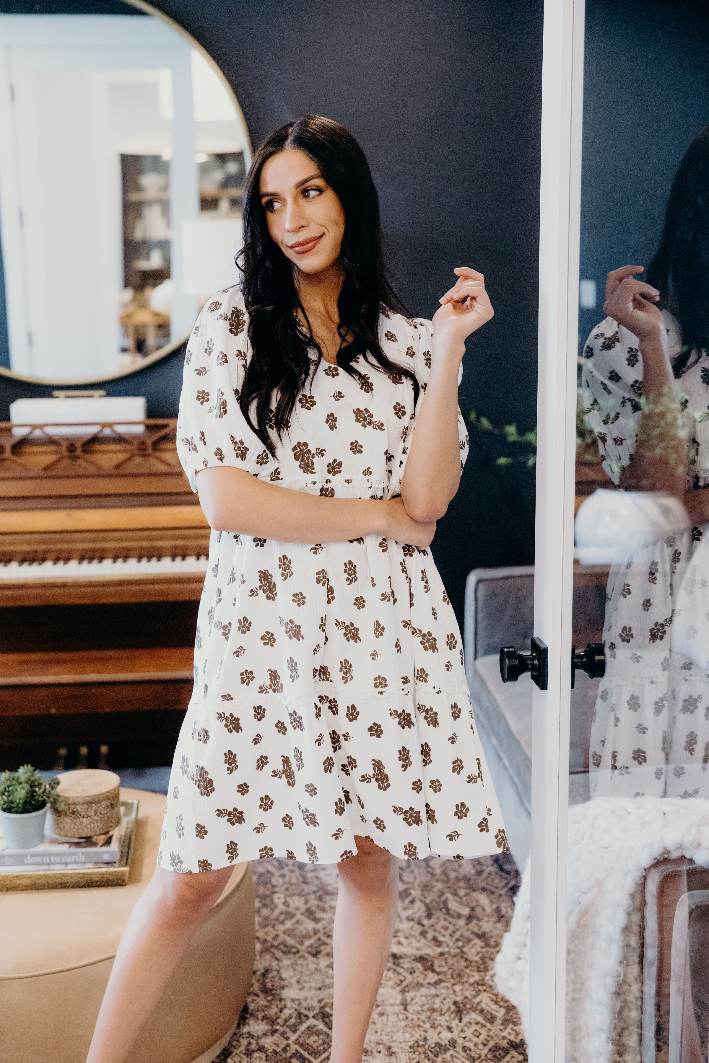 White floral knee length dress with short sleeves and v neckline.