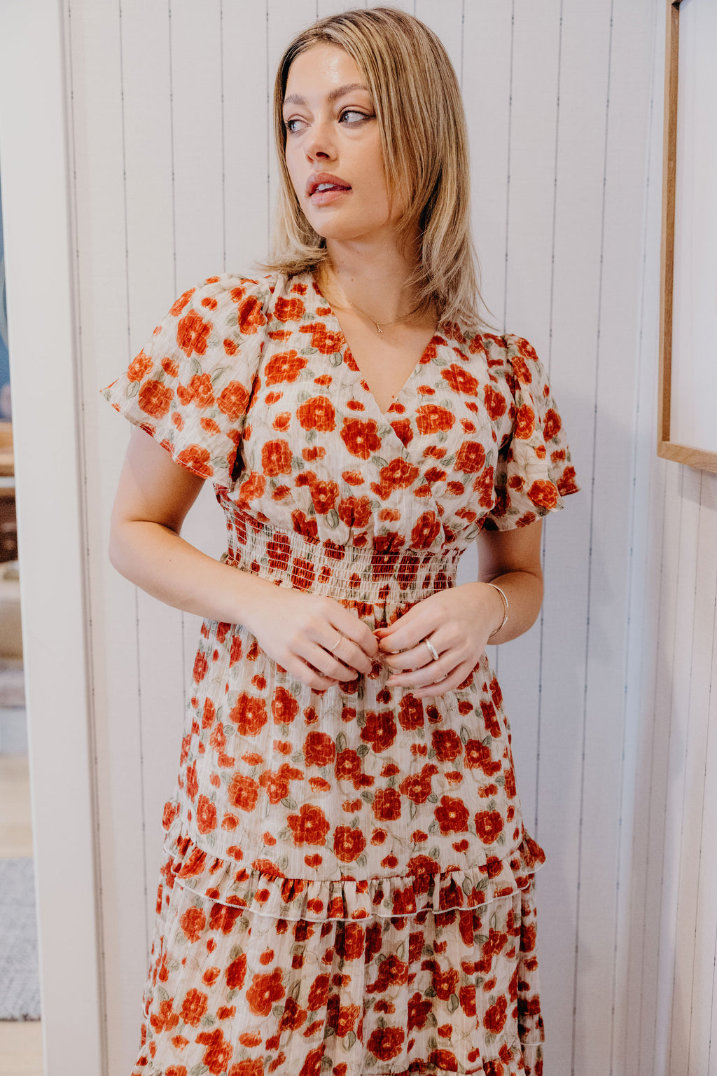 Red floral print dress with v neckline, smocked waist, and short sleeves.