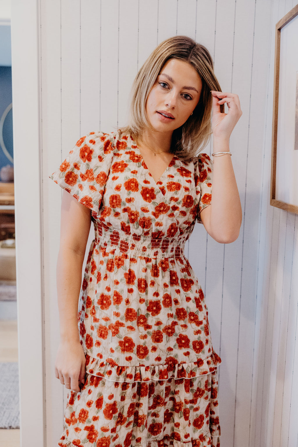 Fit and flare dress with v neckline, short flutter sleeves, smocked waist, and tiered skirt.