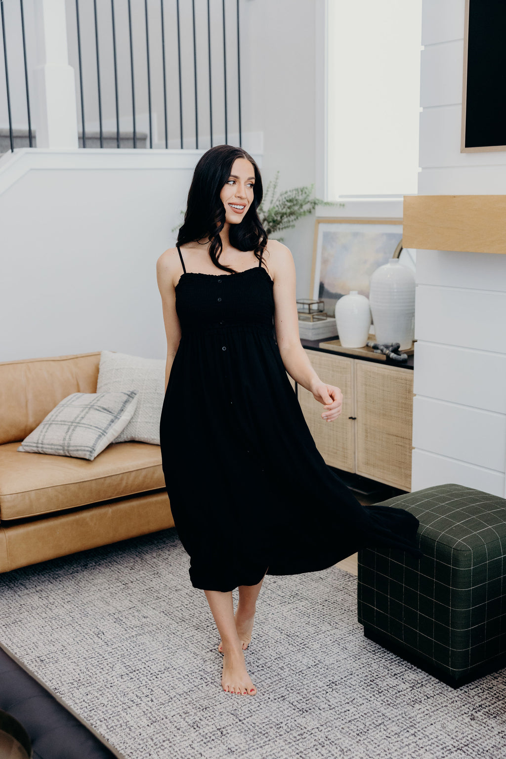 Black tank dress with smocked bodice and ruffle hem.