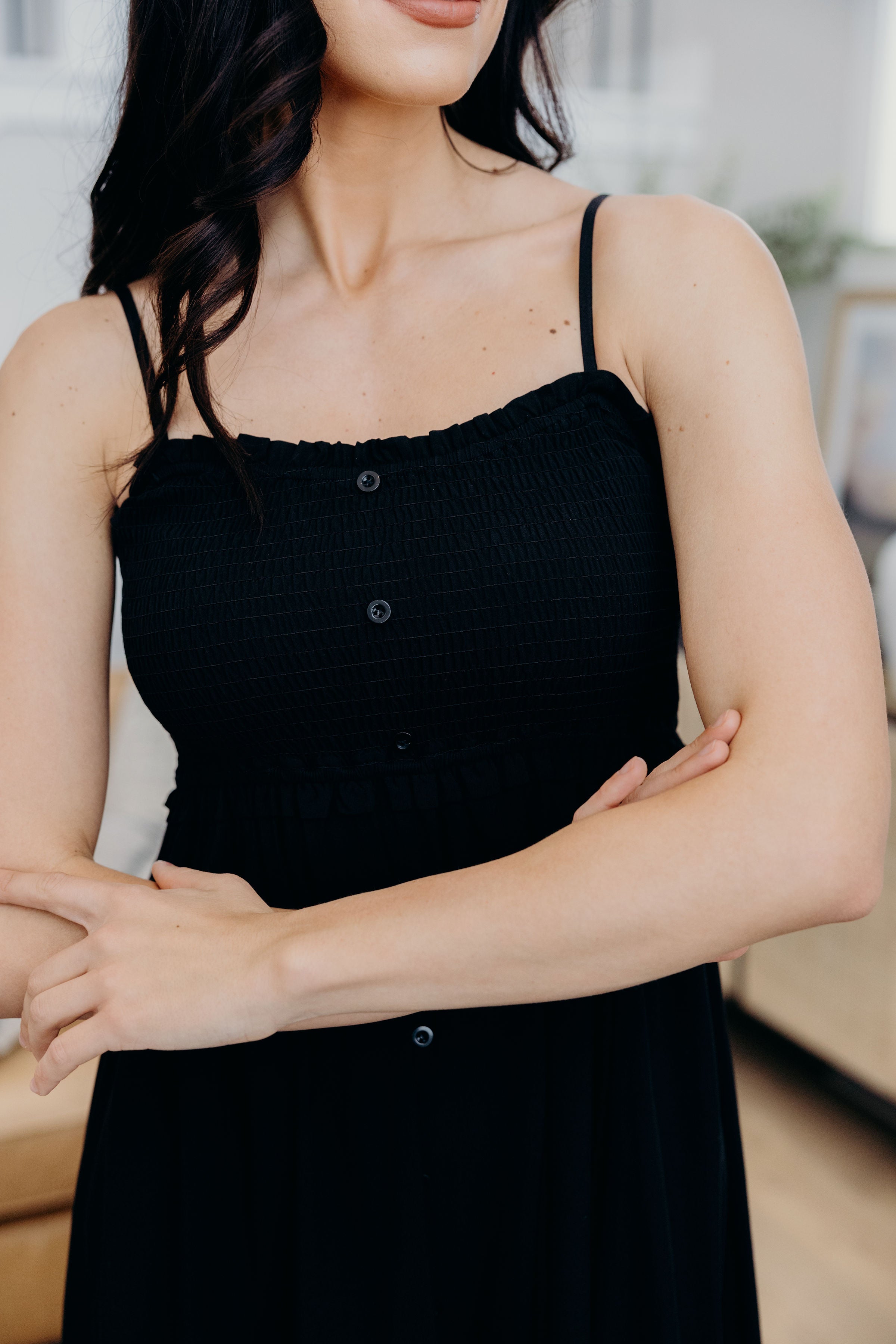 Black smocked bodice tank dress with button down detail.