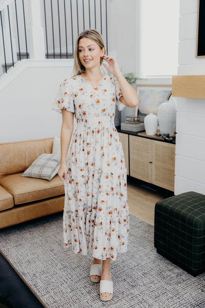 Cream and copper print dress dress with v neckline, short sleeves and tiered skirt.