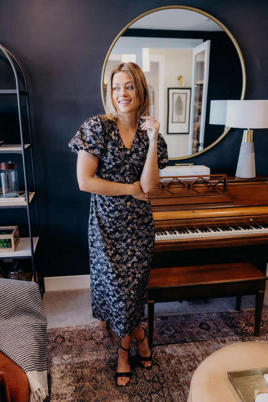 Midi length button down dress with short sleeves and v neckline.