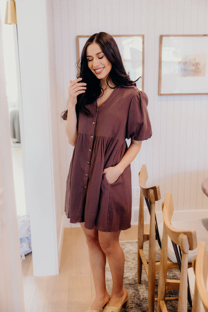 Chocolate brown button down dress with v neckline and pockets.