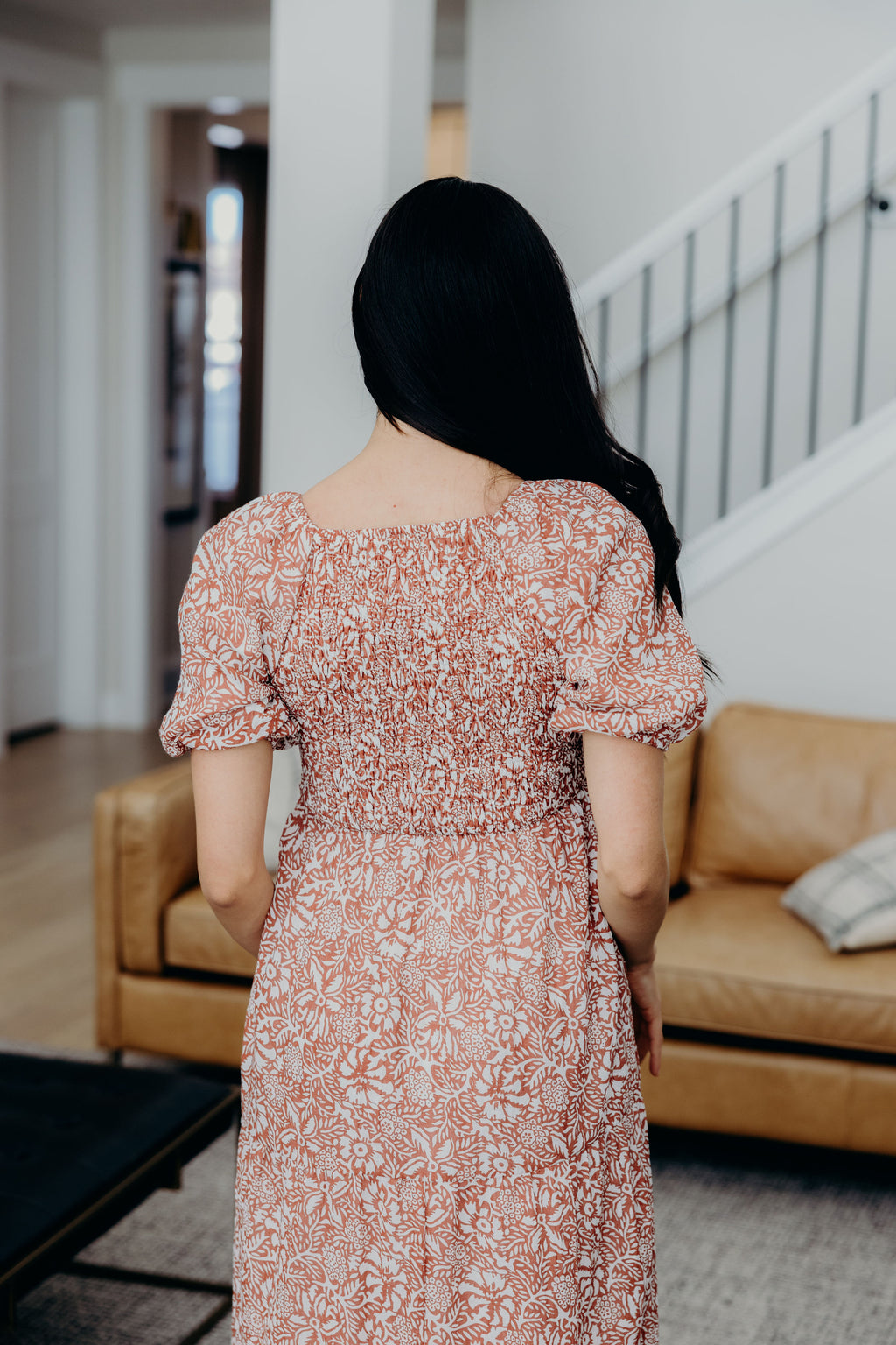 Back view of smocked bodice, square neckline, and short puff sleeves.