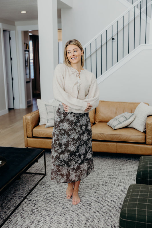 Midi length green skirt with floral print.
