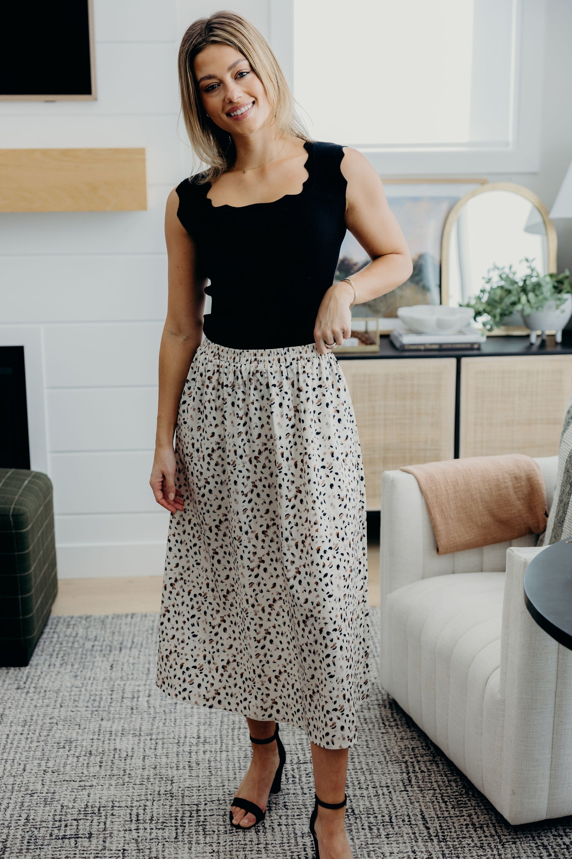 Black square neck tank with decorative scallop edging.