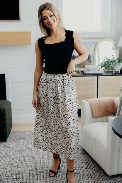 Black square neck tank with decorative scallop edging.