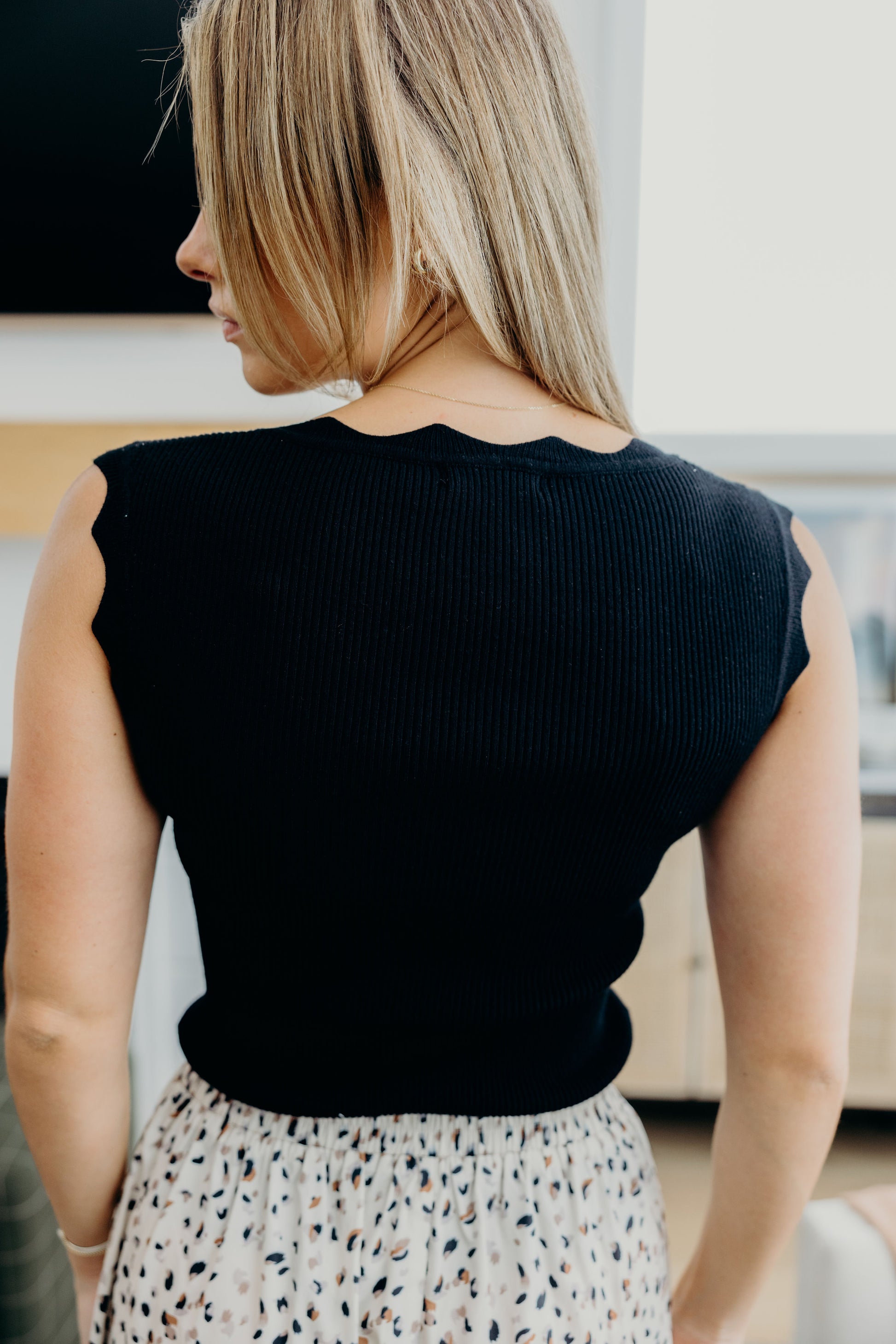 Back view of ribbed sweater tank with scallop edge detail.