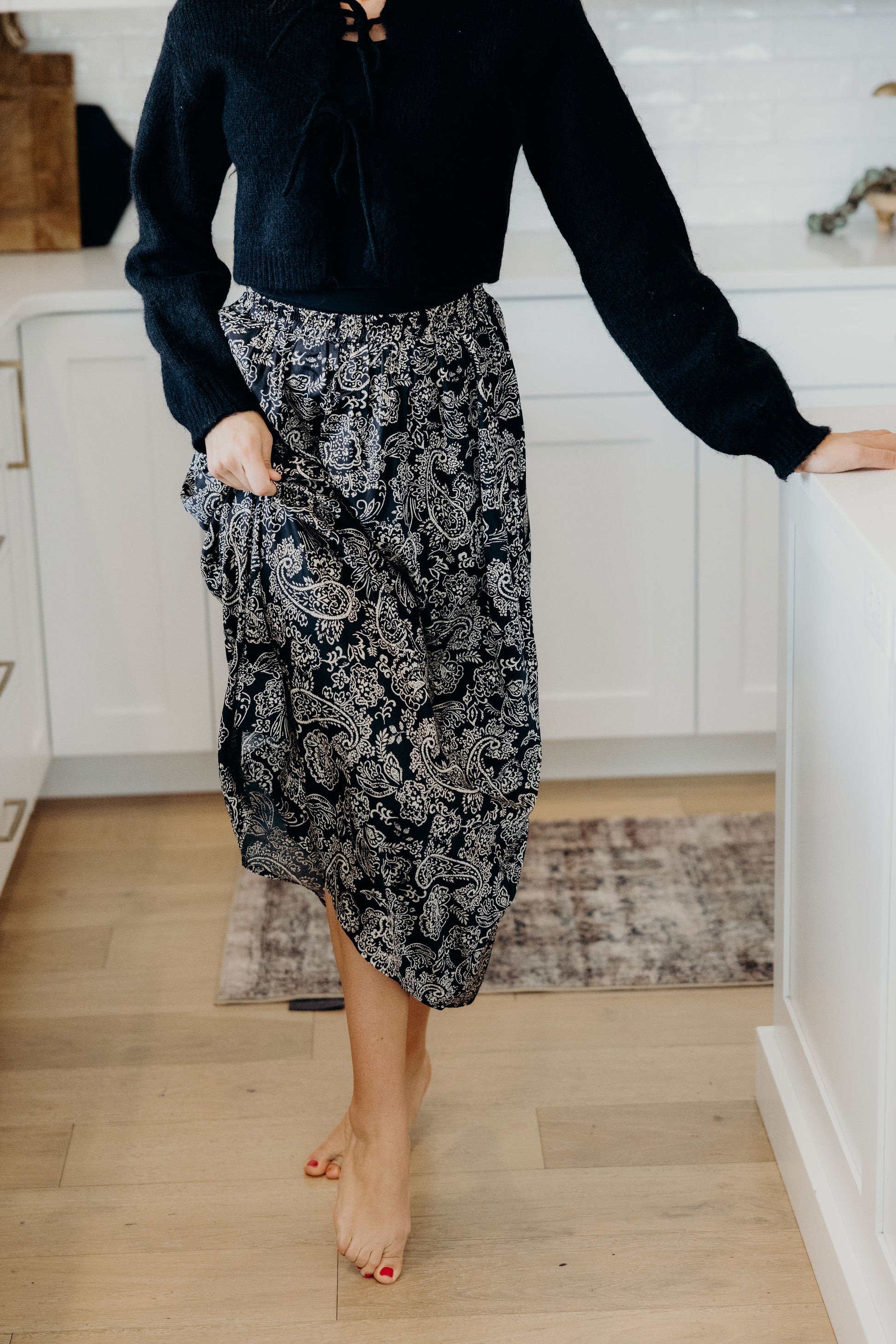 Black paisley print skirt with a line silhouette.