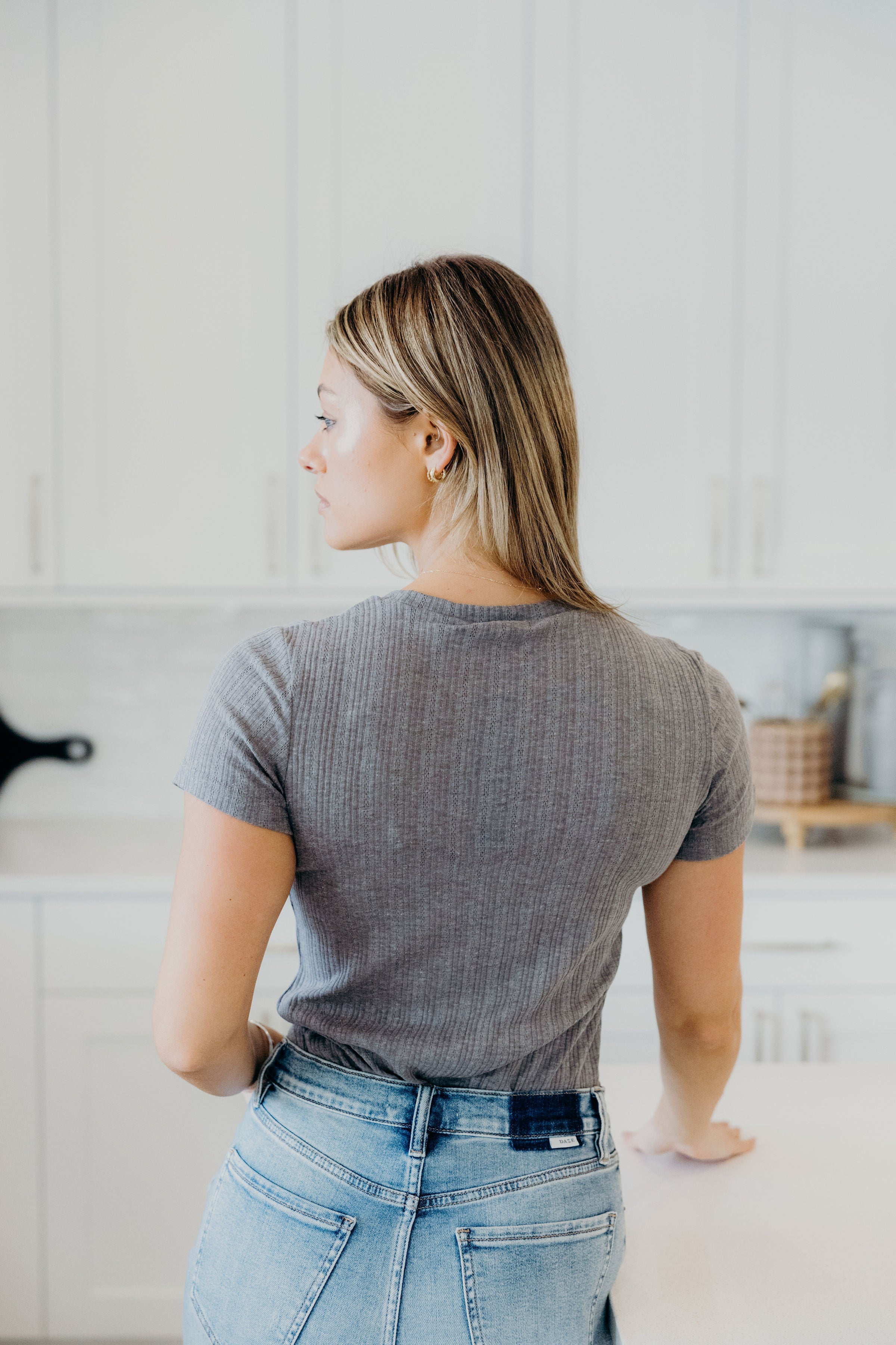Back view of pointelle textured iron gray top with short sleeves.