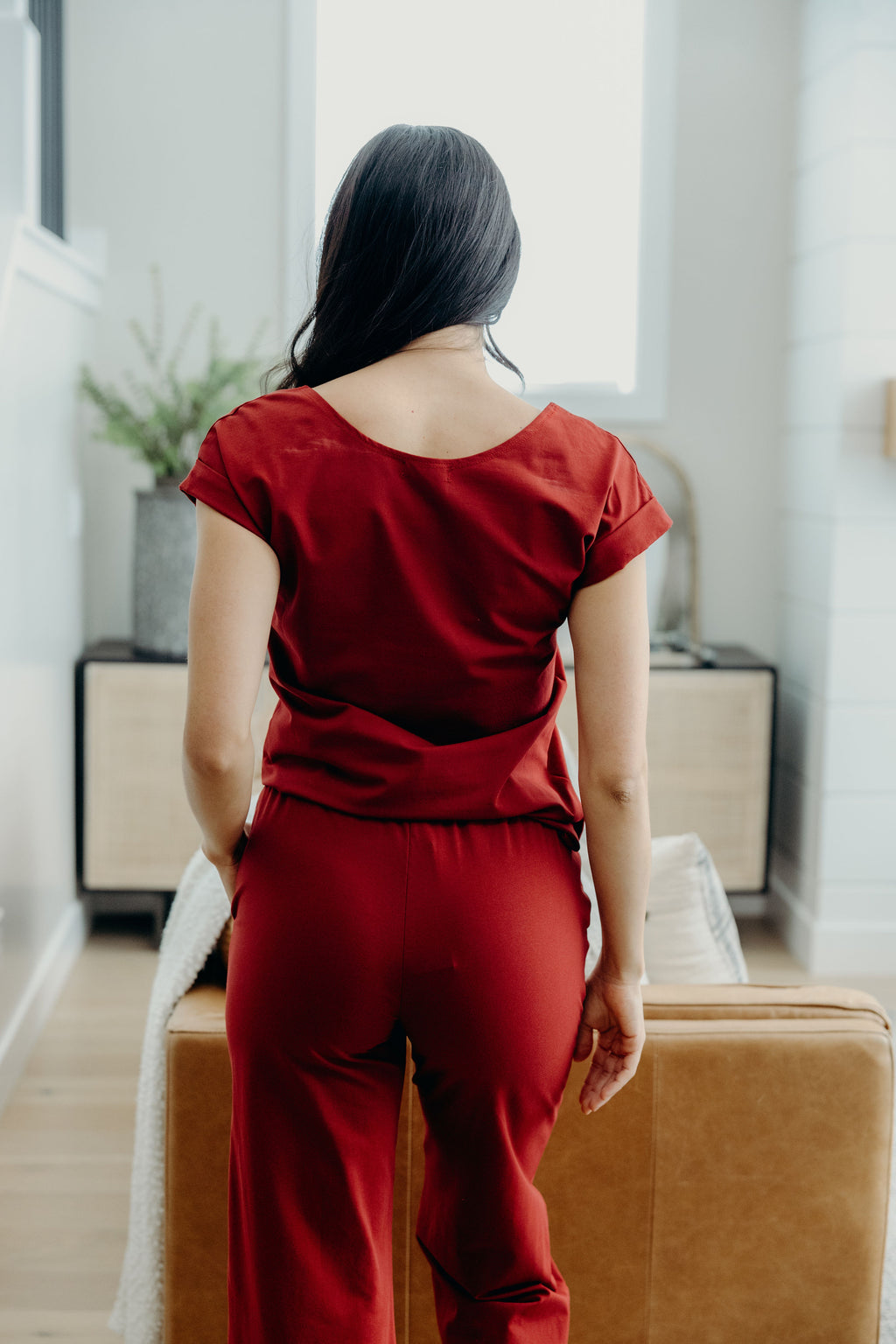Back view of dark red tee with scoop neckline and cuff detail on sleeve.