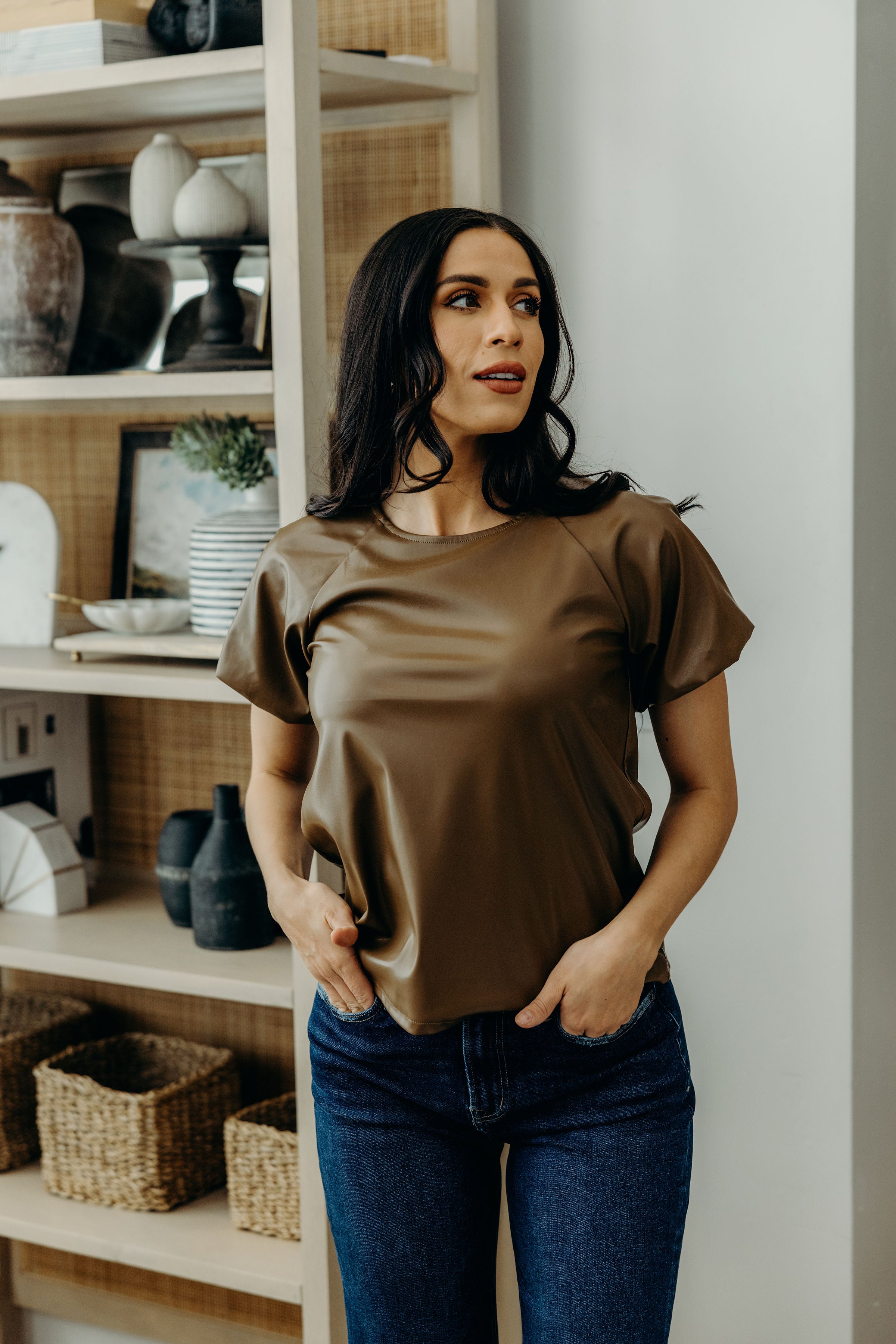 Short sleeve faux leather top with high neckline and short sleeves.