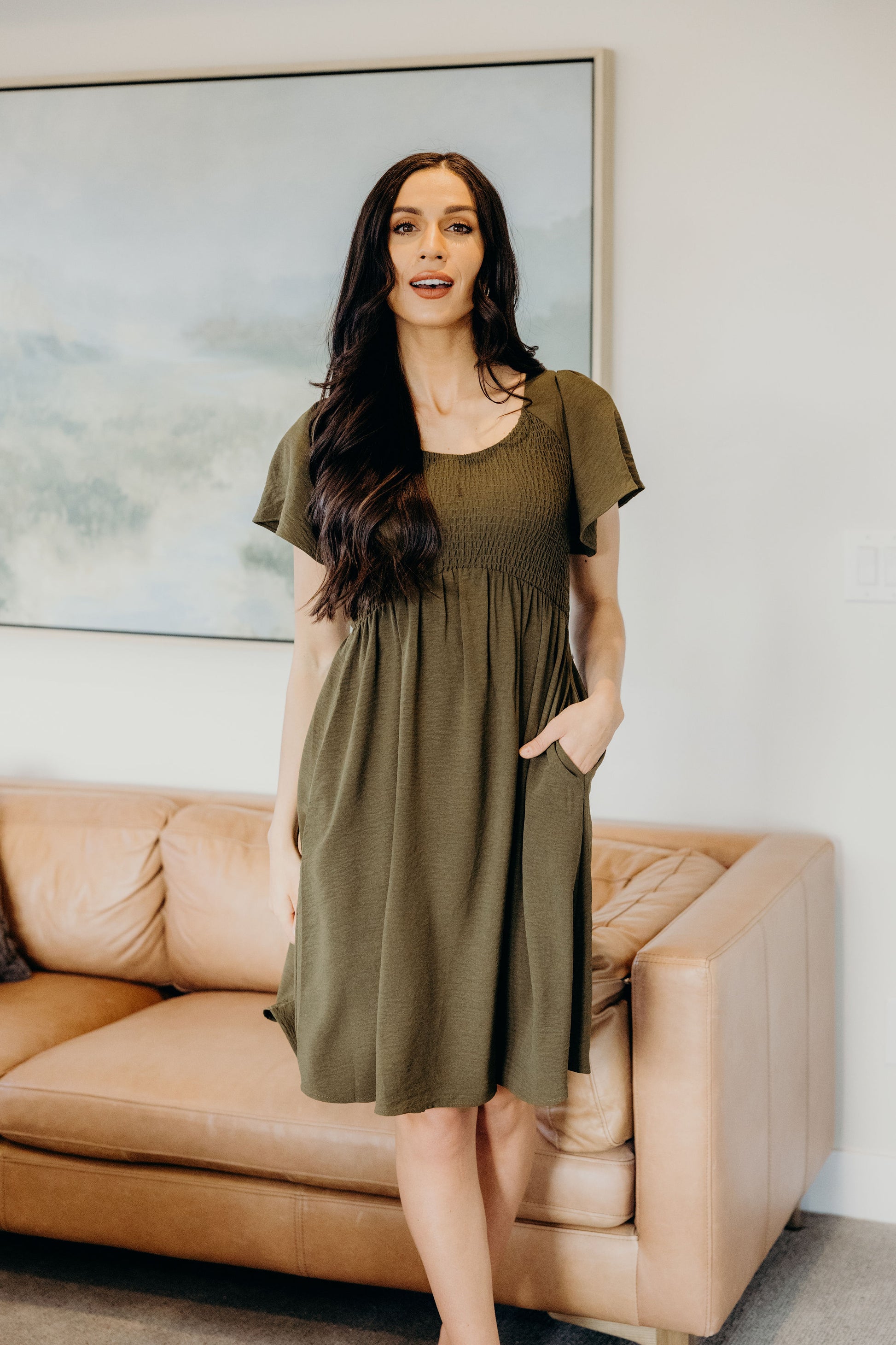 Short dress with smocked bodice with flutter sleeve and pockets.