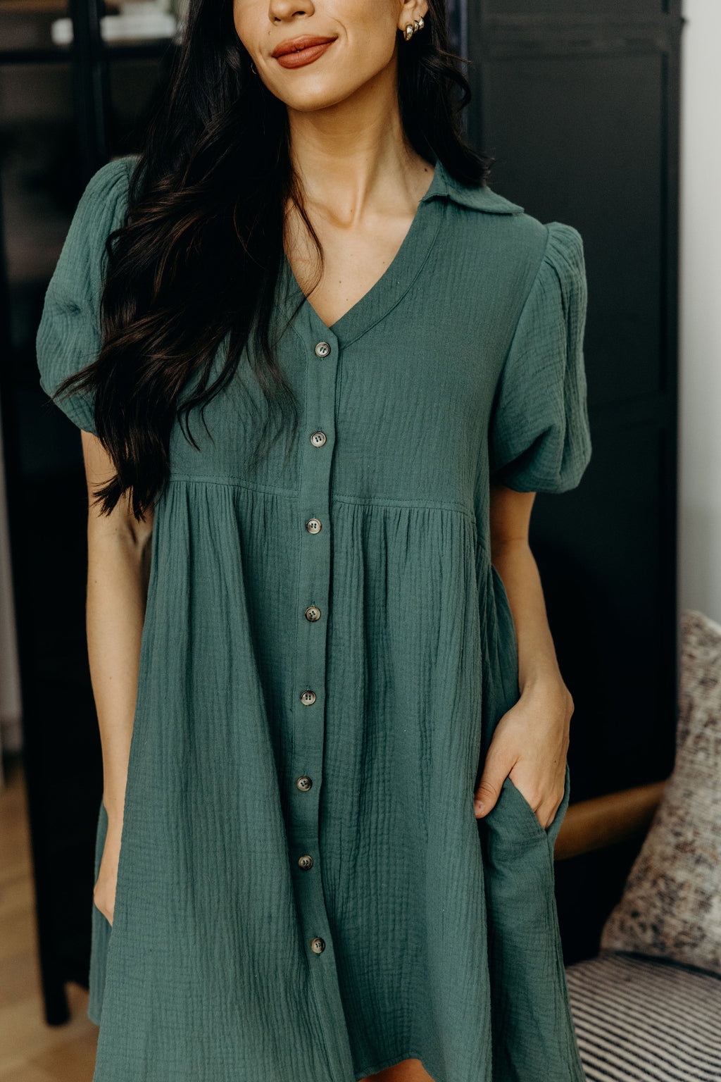 Button down dress with v neckline, collar, short sleeves, and pockets.