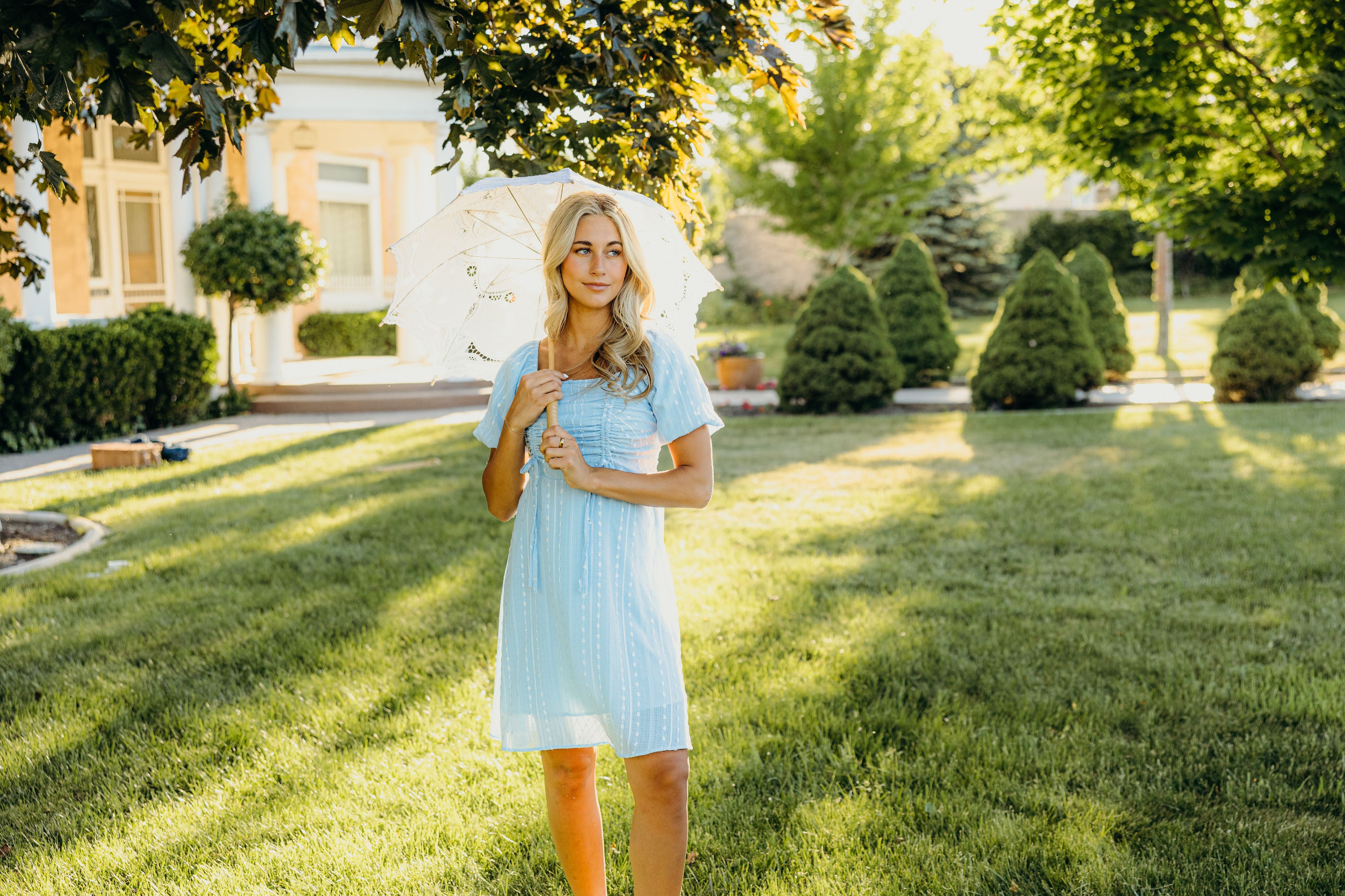 Short blue dress with textured detail and ruching on the bust.