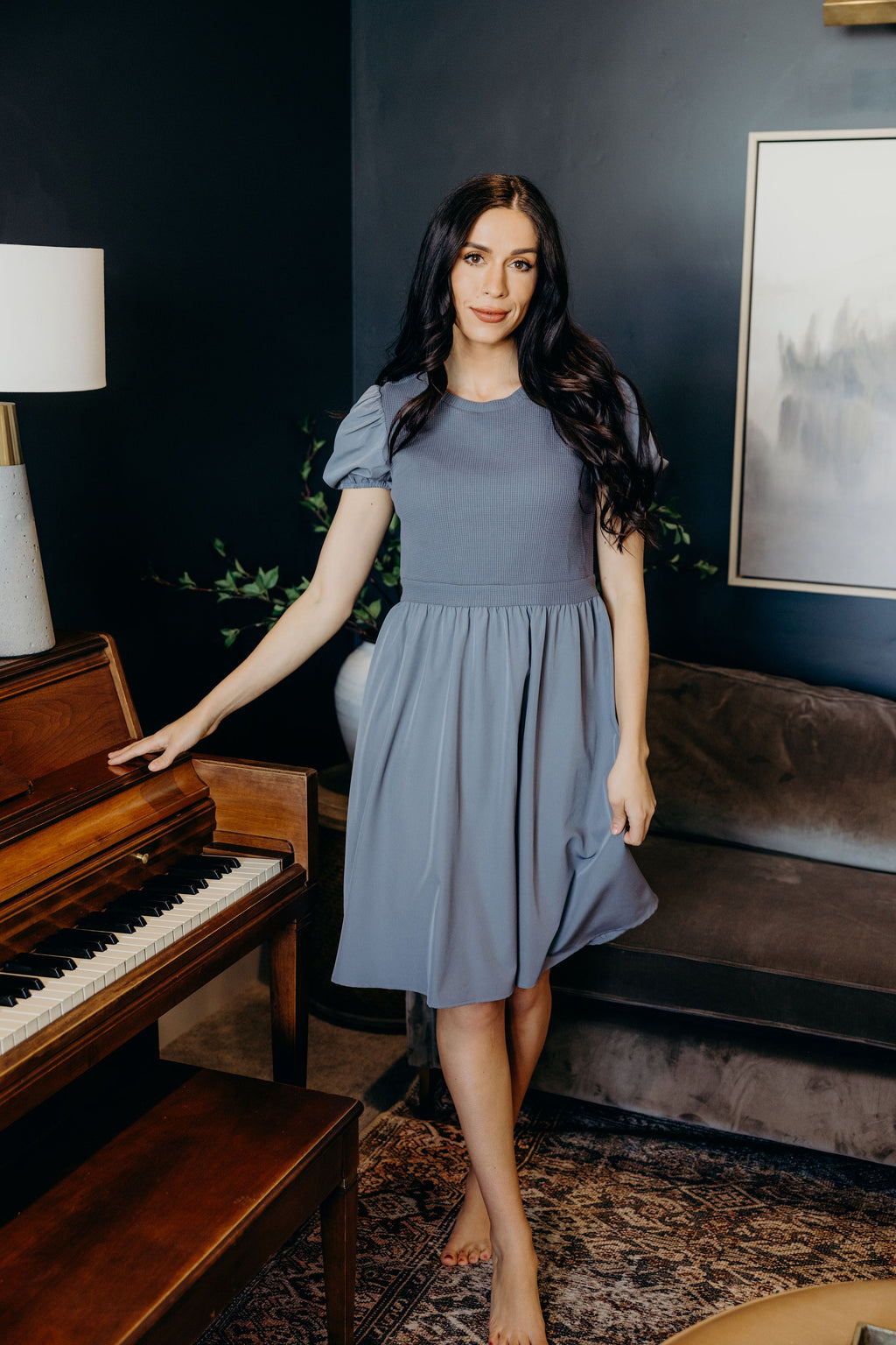 Short sleeve knee length dress with high neckline, puff sleeves, and waffle textured bodice.