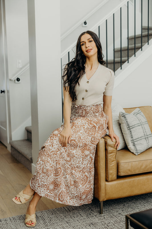 Maxi length skirt with copper paisley pattern and smocked waist.