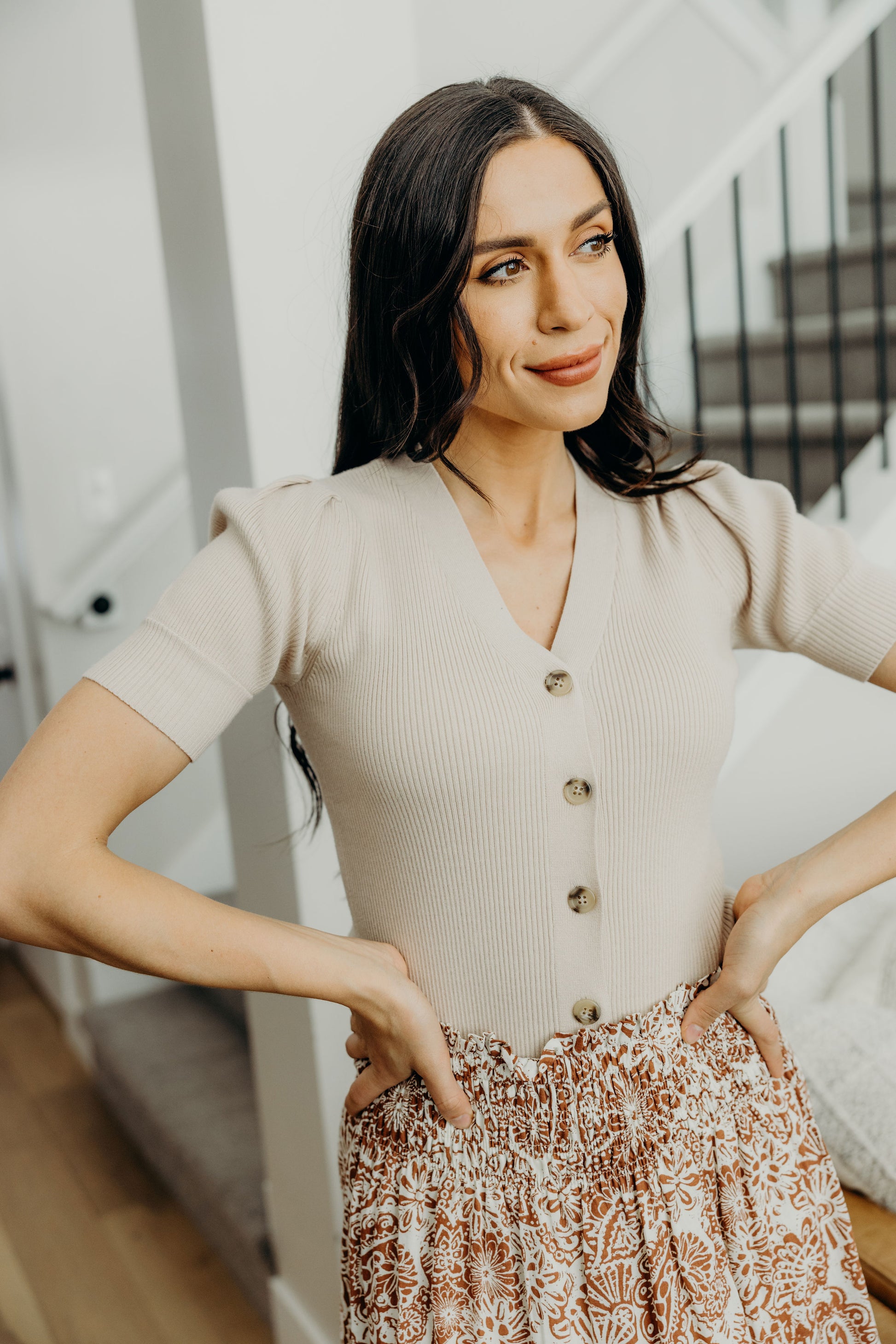 Ribbed sweater with buttons down front and short sleeves.